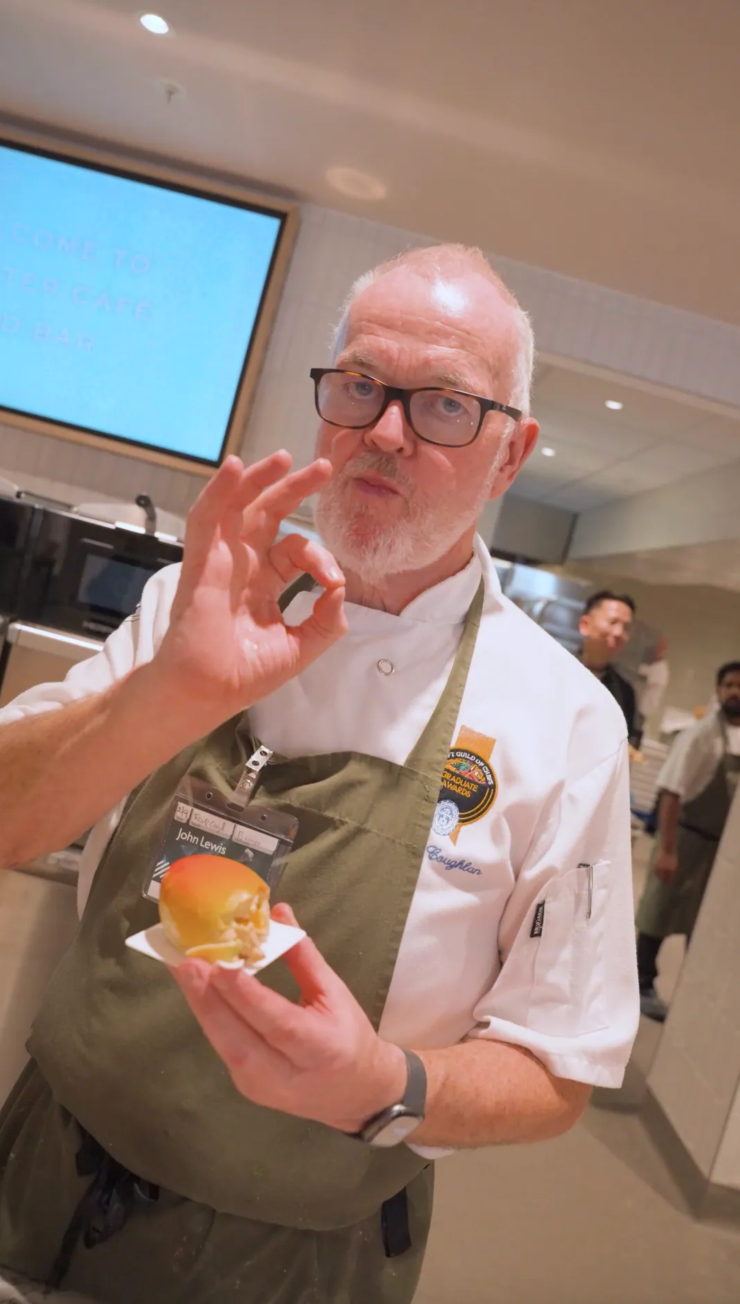 A chef at John Lewis Oxford Street with a pâtisserie, giving the OK