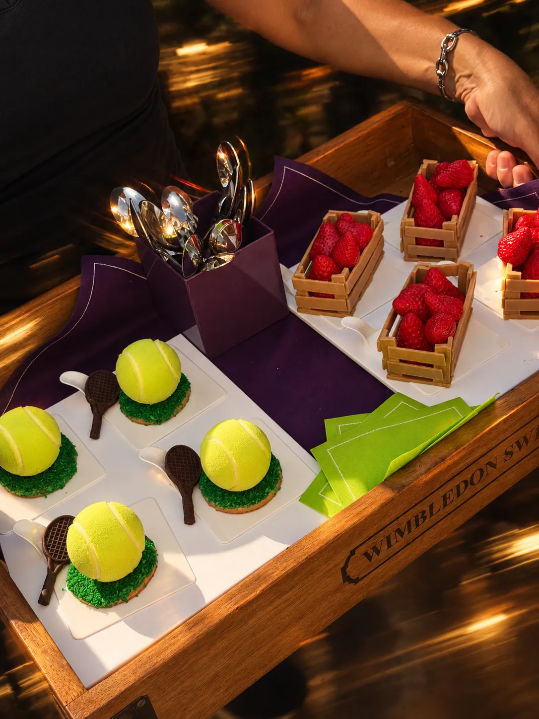 A tray of tennis ball and strawberry crate pâtisserie