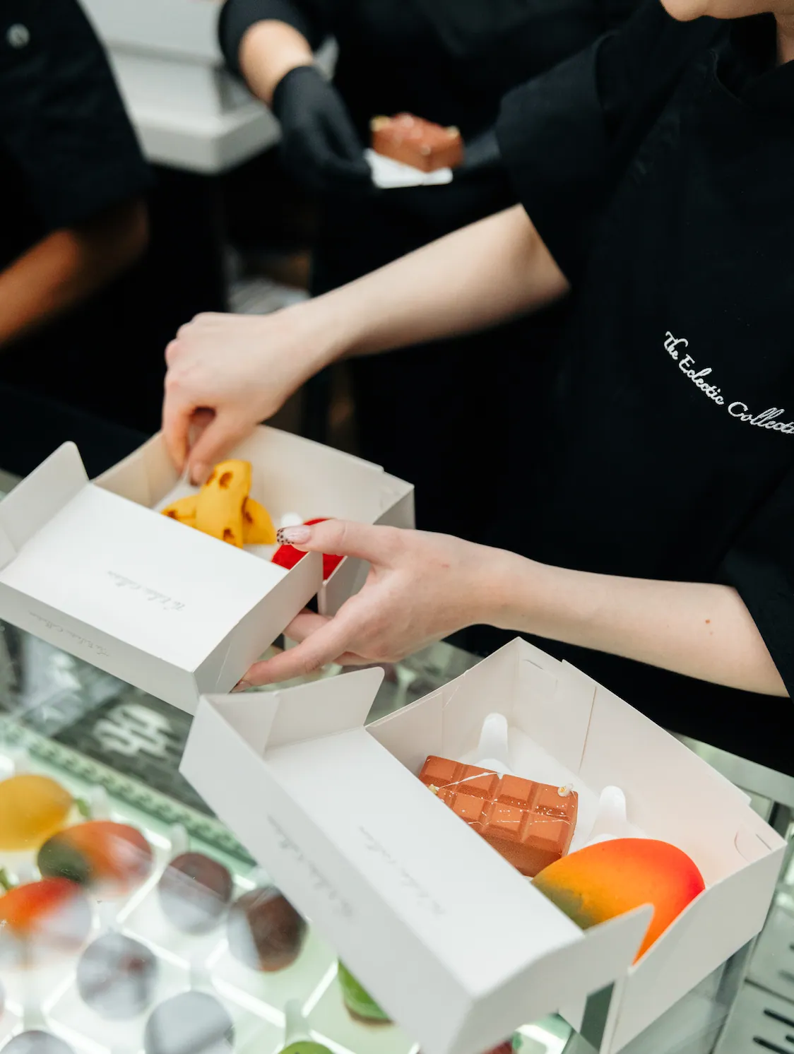 Pâtisserie being boxed up for collection